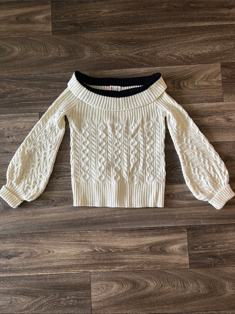 L'ATISTE Cream Off-the-Shoulder Cable Knit Sweater with Black Trim